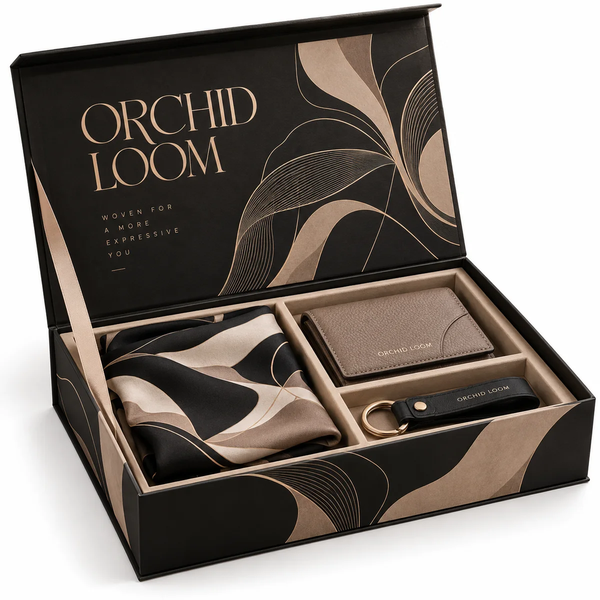 Open black Orchid Loom book-style rigid gift box with champagne abstract artwork, folded fabric and fitted leather accessory sections.
