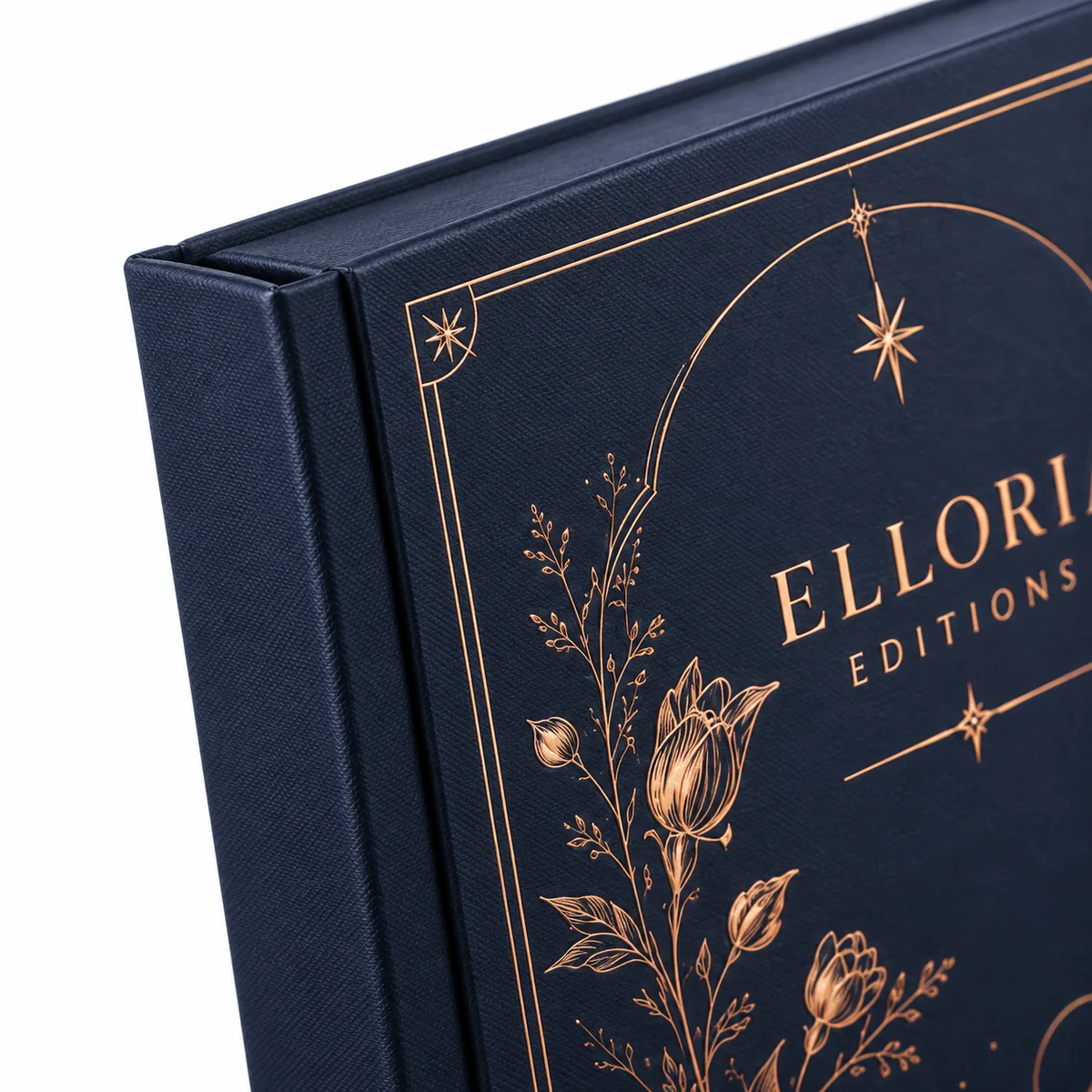 Close-up of a navy book-style rigid box showing textured wrapped board, copper foil floral details and the spine hinge.