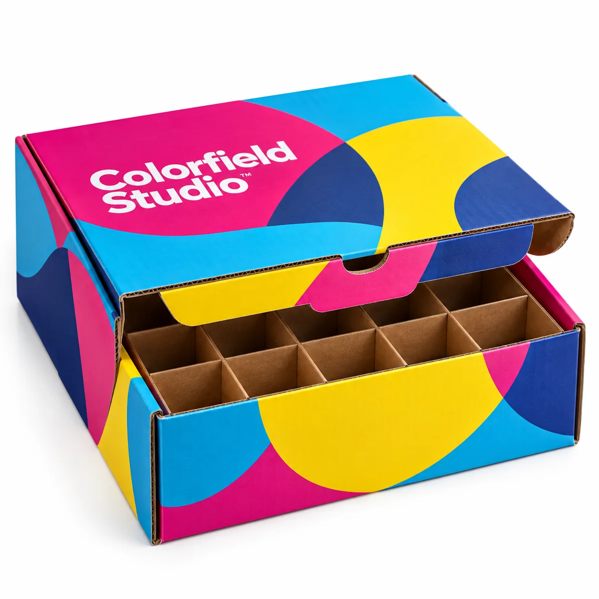 Colorfield Studio cardboard mailer box with visible dividers, bold magenta, cyan, yellow, and blue graphics, and a partly open lid.