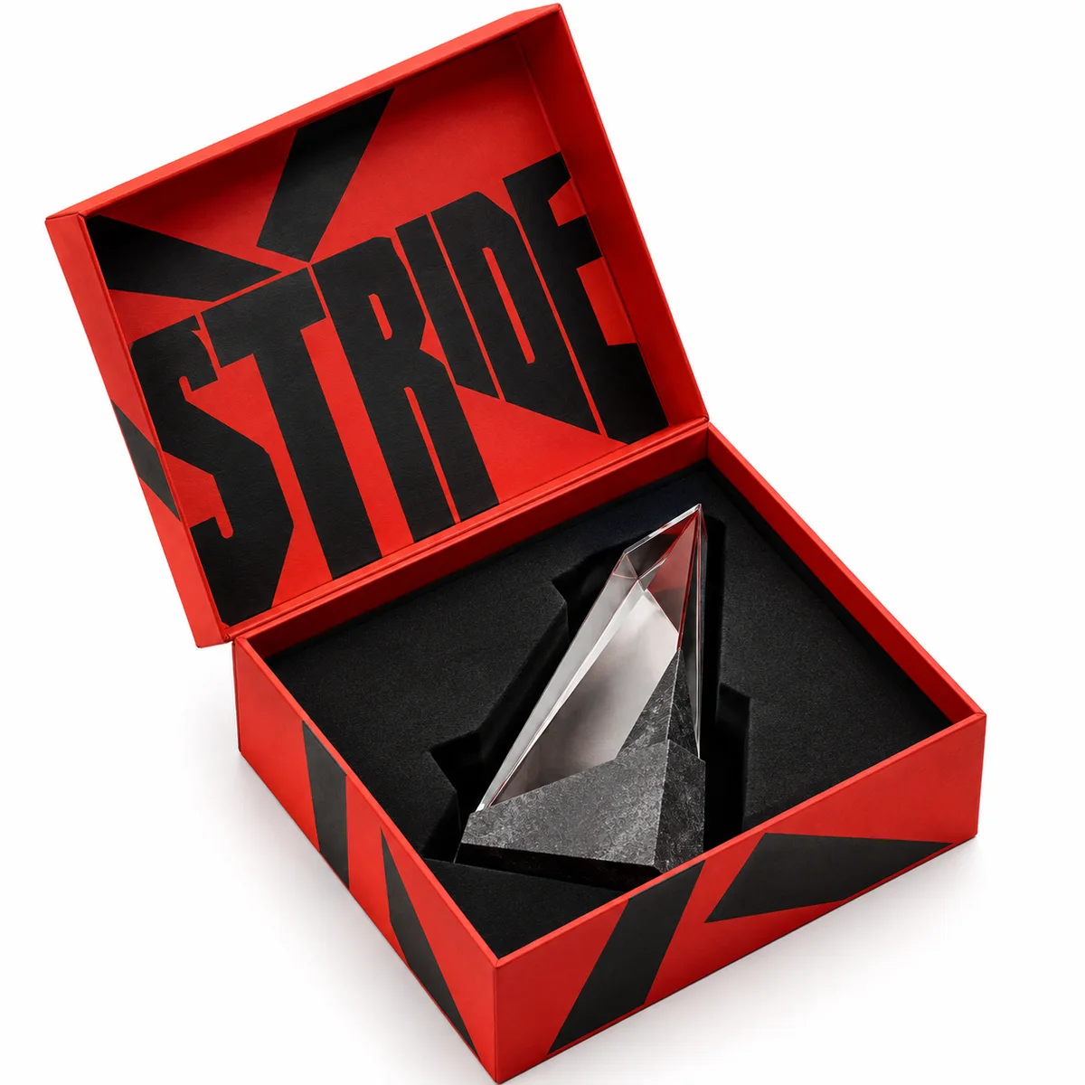 Open red award presentation box with oversized black typography and an angular crystal trophy held in a fitted black insert.