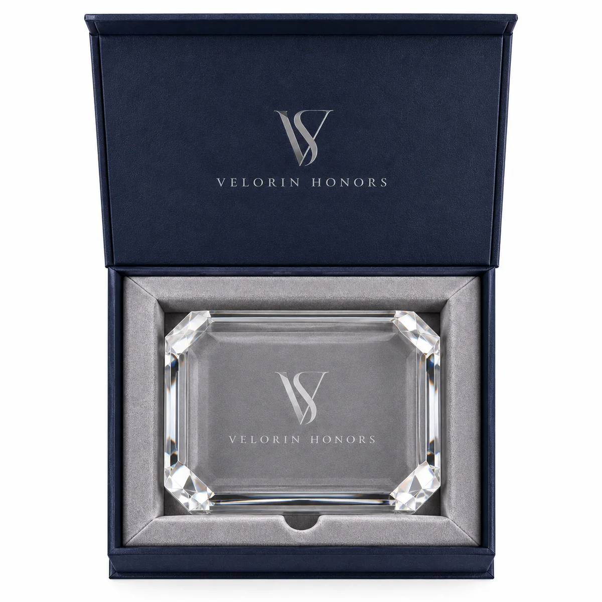 Top-down view of a navy award presentation box displaying a rectangular crystal plaque in a fitted dove-gray velvet insert.