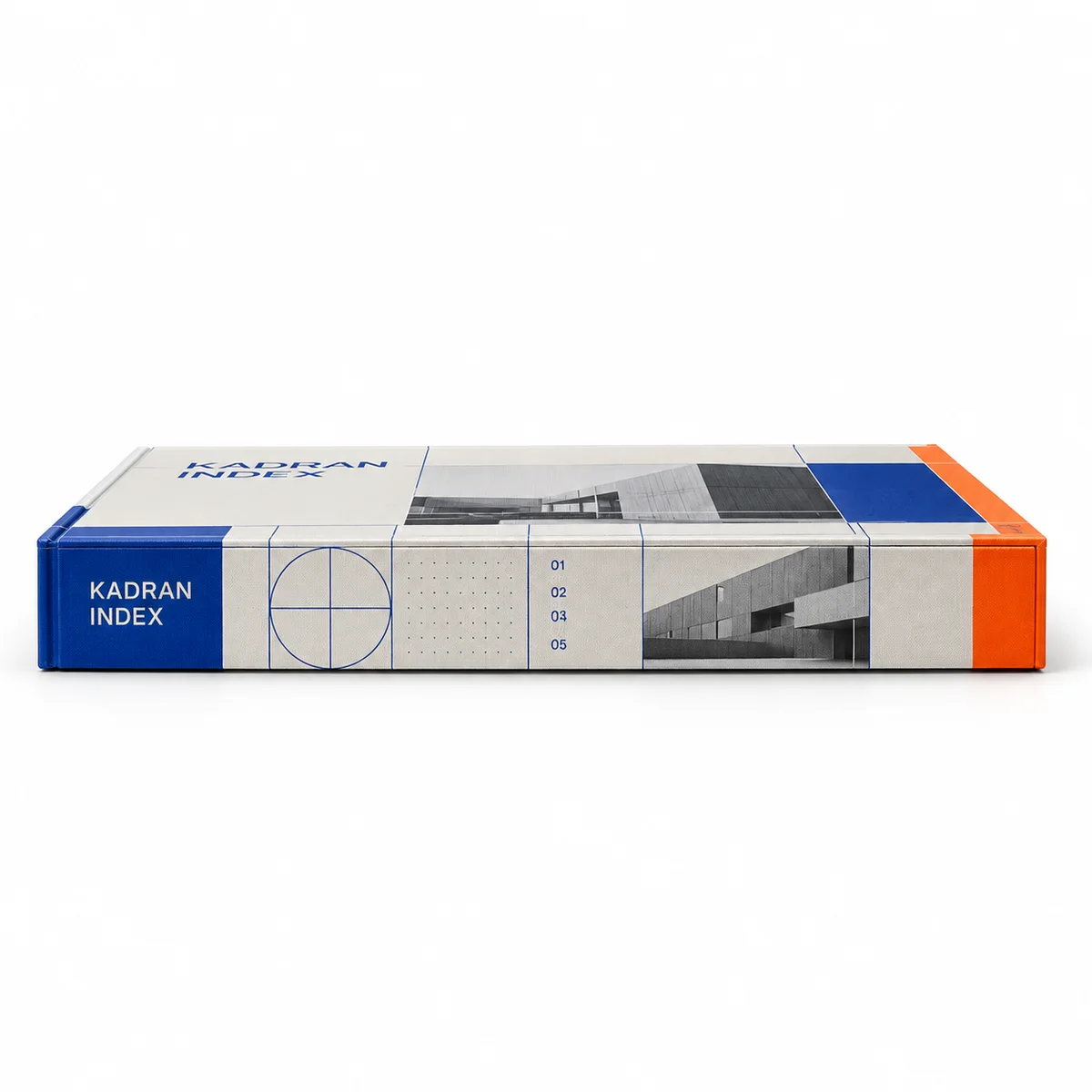 Side profile of a slim Kadran Index booklet box with cobalt grid graphics, architectural imagery, and a bright orange end panel.