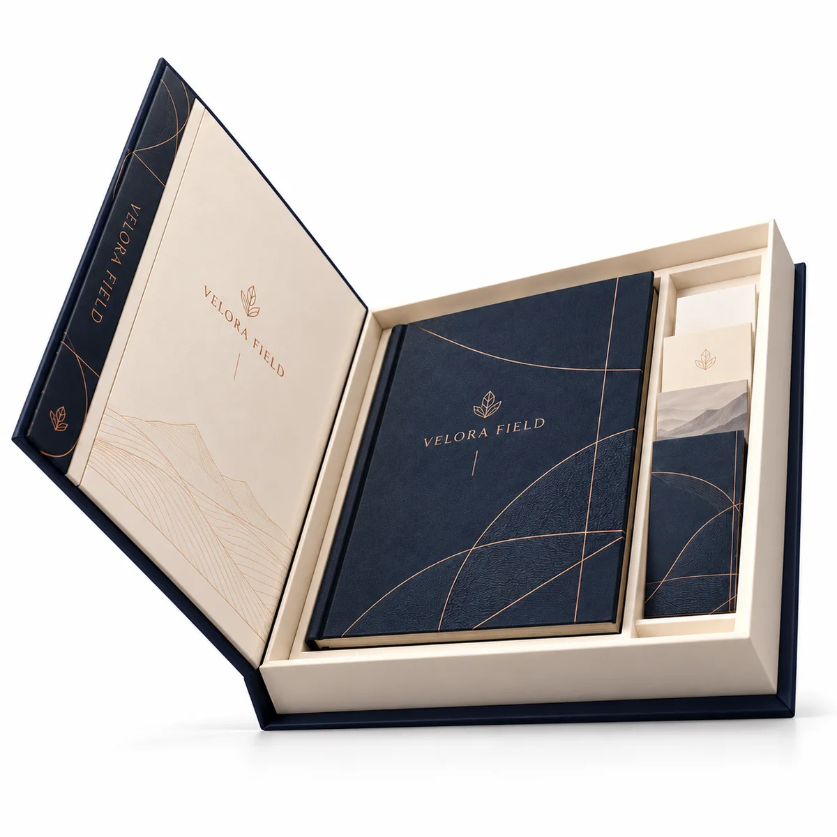 Low-angle view of an open VELORA FIELD booklet box showing the raised hinged cover, thick ivory tray, and navy booklet.