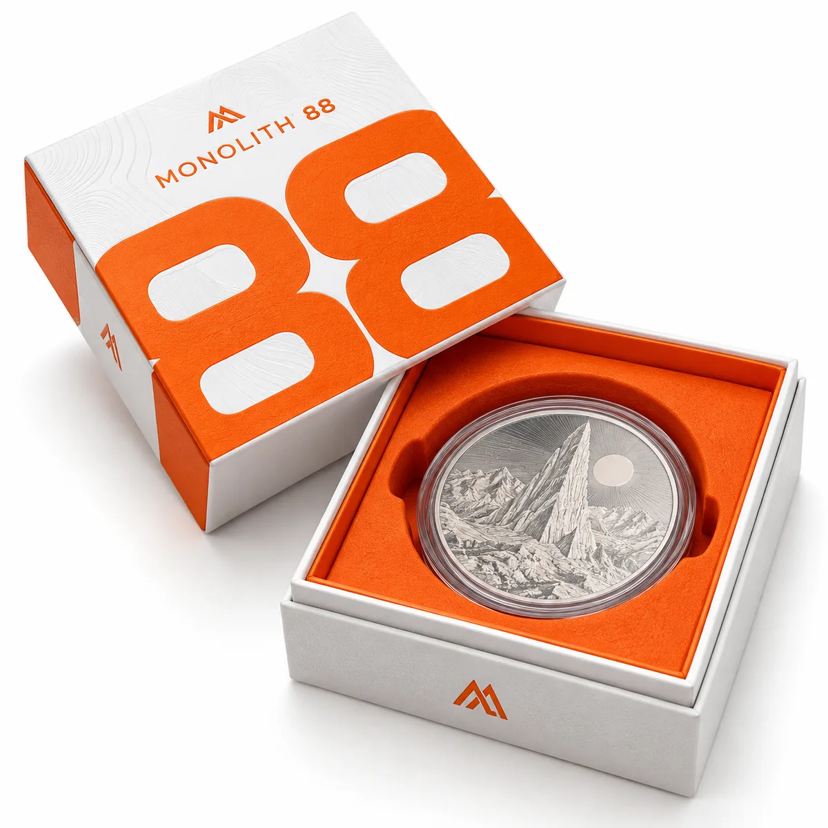 White and orange rigid coin presentation box with oversized typography and an orange insert holding a silver coin.