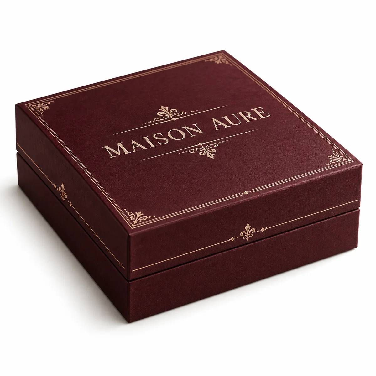 Closed burgundy MAISON AURE two-piece rigid presentation box featuring vintage lettering and decorative parchment-colored borders.