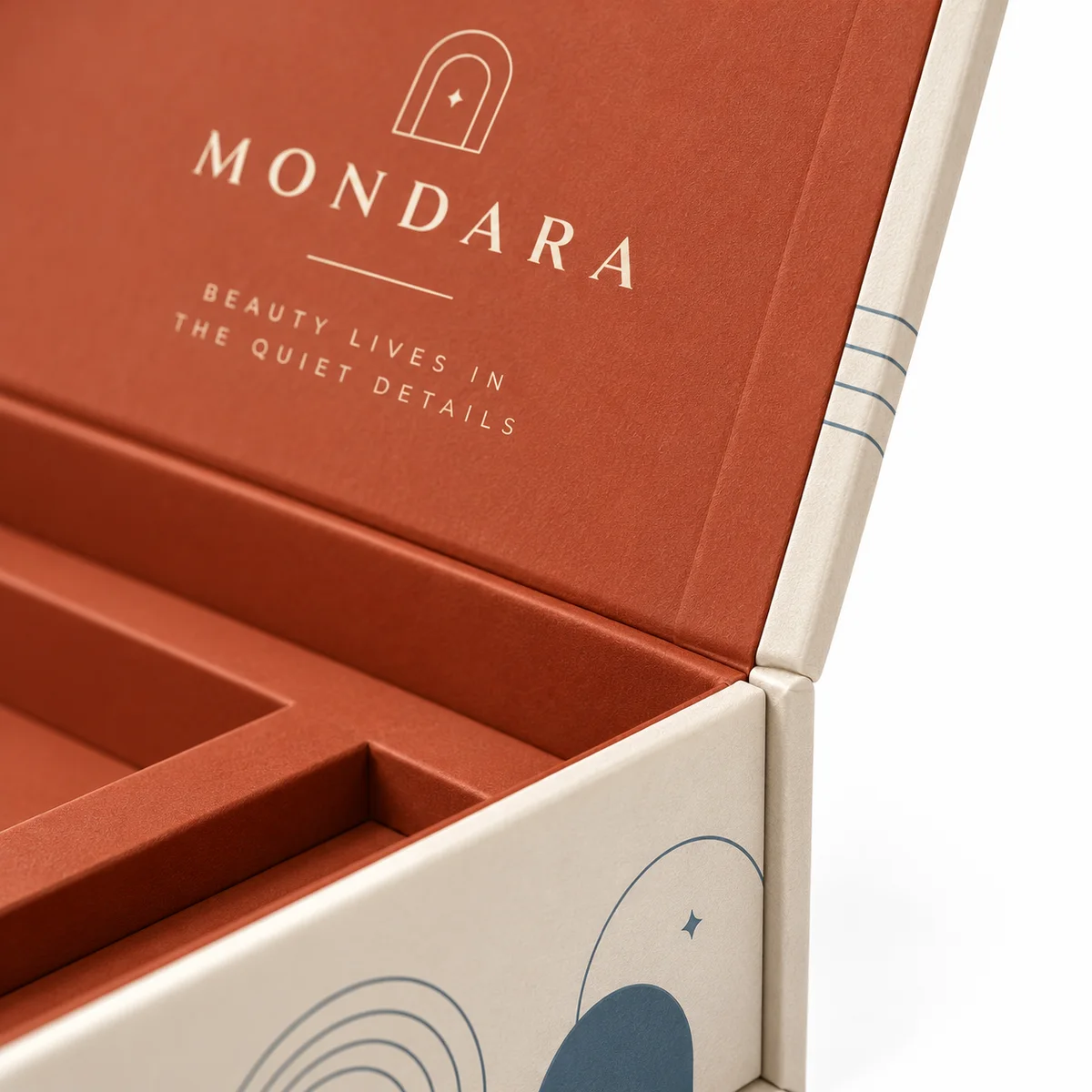 Close-up of a custom flip top box hinge and wrapped ivory edge, with terracotta inner-lid branding and slate-blue linework.