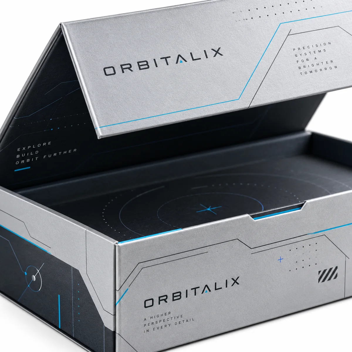 Close-up of an open ORBITALIX flip top box with silver-gray panels, cyan circuit-like lines and a dark patterned interior.