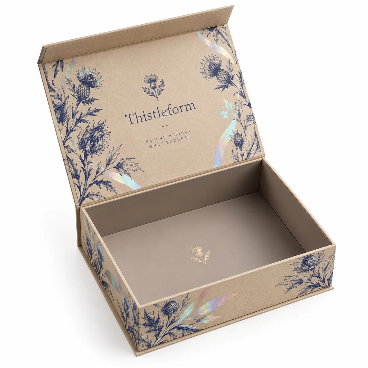 Open Thistleform rigid gift box with kraft-colored surfaces, indigo floral artwork, and subtle holographic leaf accents.