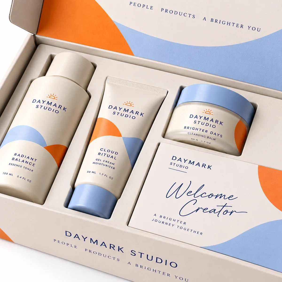 Close-up of DAYMARK STUDIO influencer kit packaging showing fitted insert compartments, branded skincare containers and a welcome card.