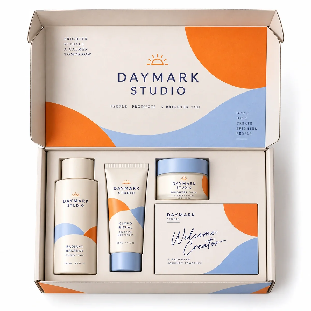Overhead view of DAYMARK STUDIO influencer kit packaging with three skincare products and a welcome card in a fitted insert.