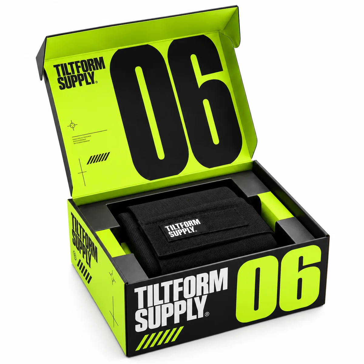 Open Tiltform Supply magnetic gift box with acid-lime graphics, oversized 06 numerals, and a fitted tray holding a black fabric accessory.