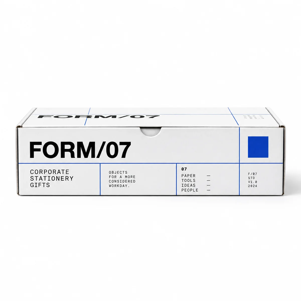 Side profile of a white FORM/07 tuck top gift box with bold black typography, cobalt blue grid lines, and a front tuck notch.