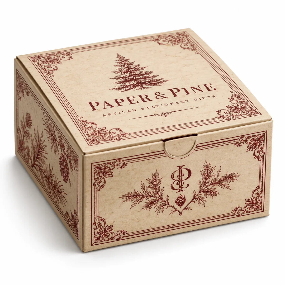 Parchment-colored PAPER & PINE tuck top gift box with wine-red ornate borders, pine illustrations, and vintage serif printing.