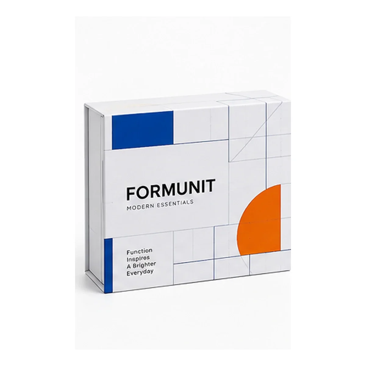 Open white FORMUNIT magnetic gift box with blue grid graphics, orange blocks, and a bright orange interior.