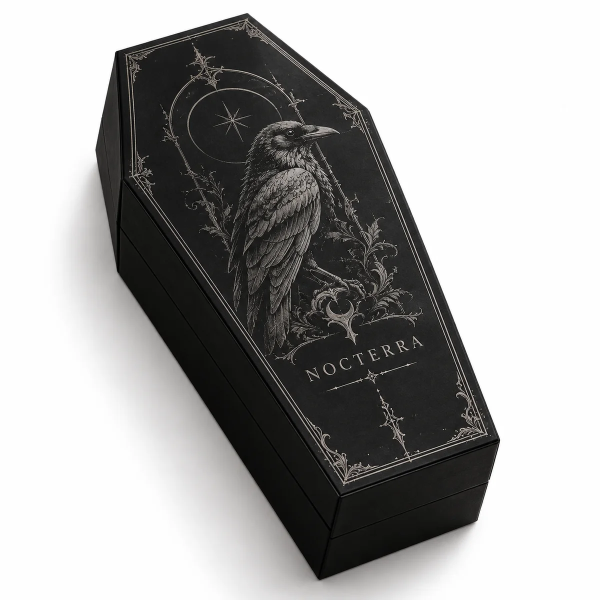 Matte black coffin gift box with intricate silver raven engraving, celestial details, and an ornate border.