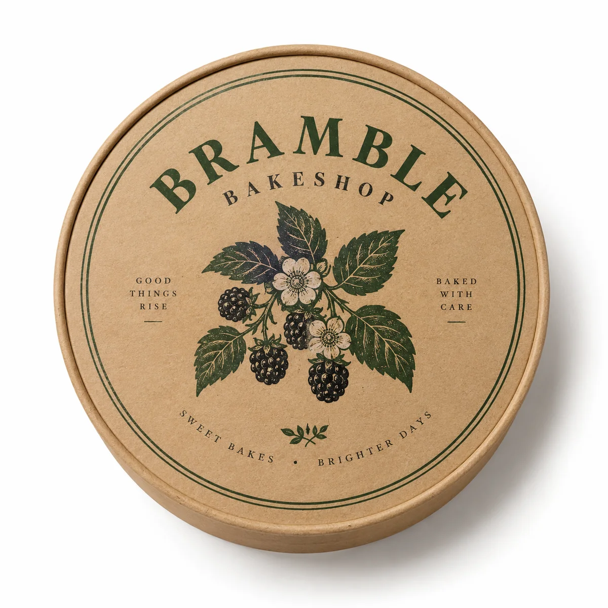 Top view of a kraft round cake box with BRAMBLE BAKESHOP branding, forest-green lettering, and blackberry botanical artwork