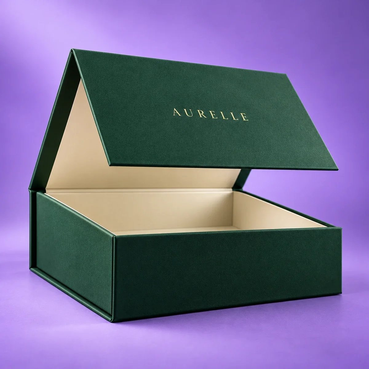 Low-angle view of a luxury emerald green magnetic gift box with a raised branded lid and cream interior