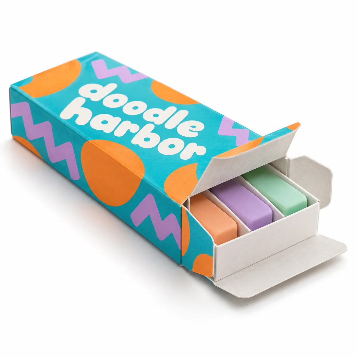 Open Doodle Harbor reverse tuck end box with turquoise graphics and three pastel erasers in a white paperboard insert.