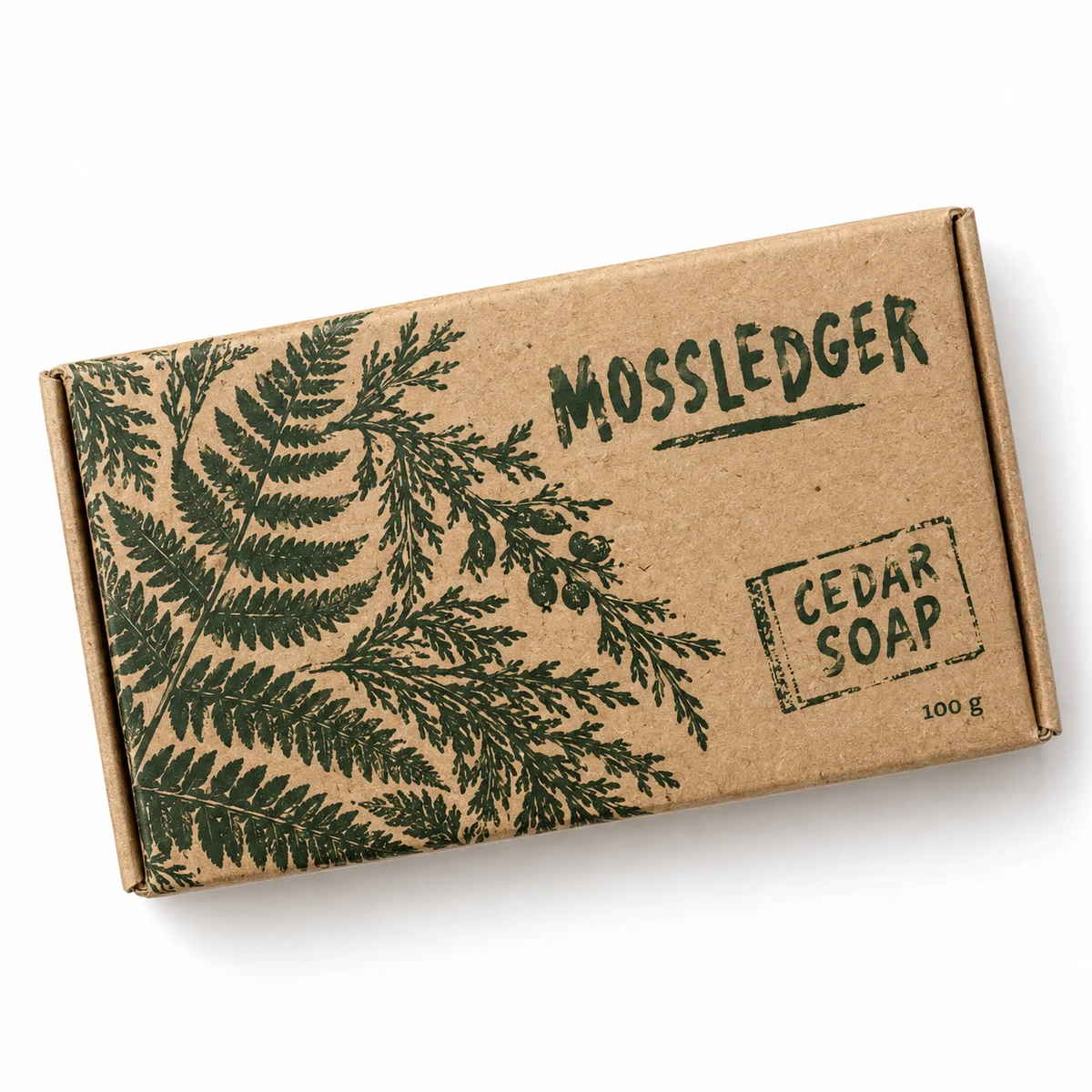 Overhead view of a kraft reverse tuck end soap box with green botanical artwork and Mossledger branding.