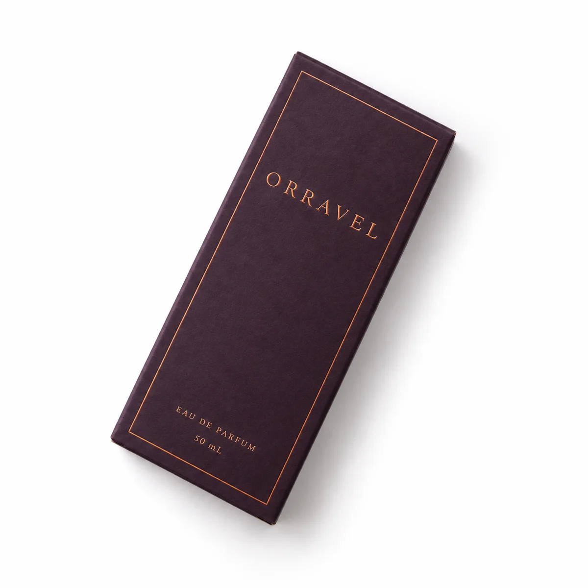 Overhead view of a plum reverse tuck end box laid diagonally on white, with copper lettering and a fine border.