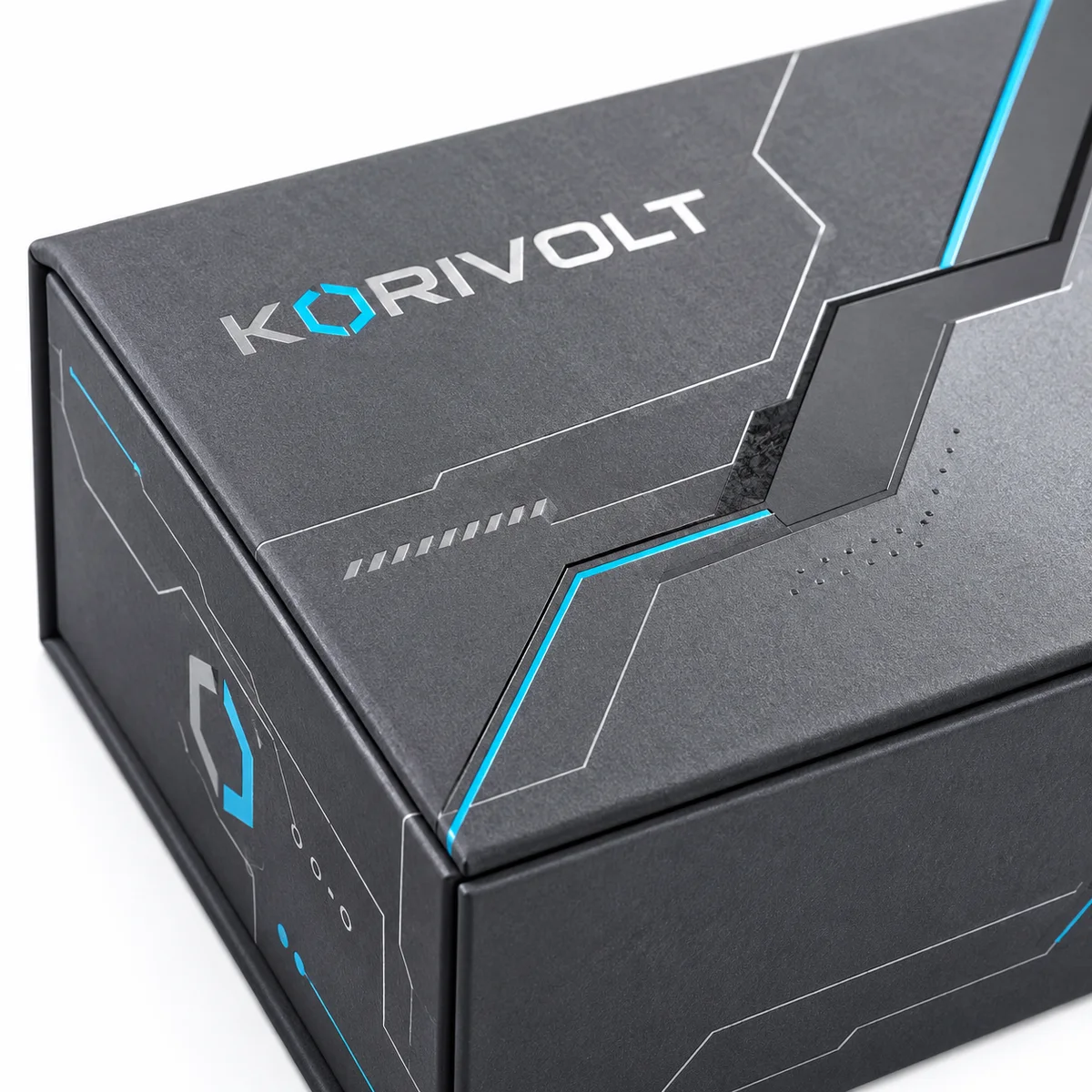 Macro view of a Korivolt magnetic closure box showing a charcoal textured surface, cyan geometric lines, and precise lid seams.