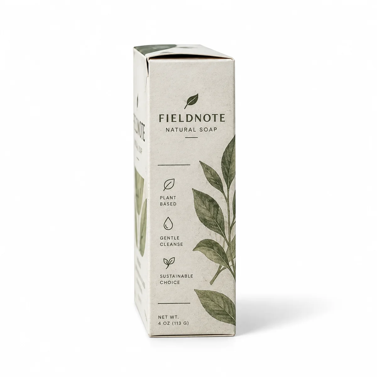 Side-profile view of a white tuck top soap box with FIELDNOTE branding, olive botanical graphics, and textured paperboard.